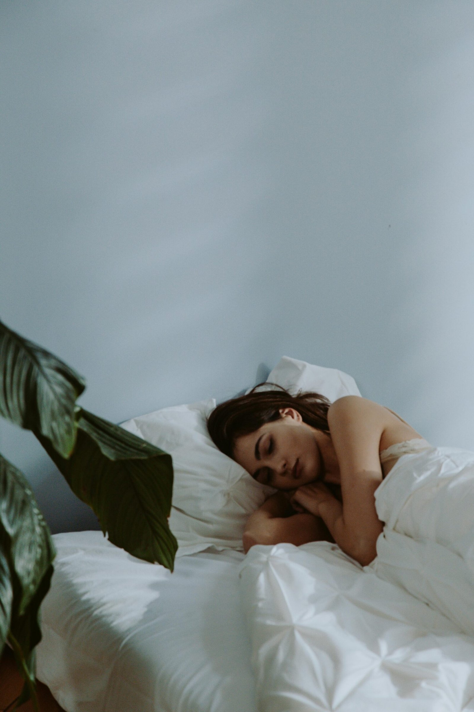 Woman sleeping peacefully representing improved sleep from AI sleep tracker insights