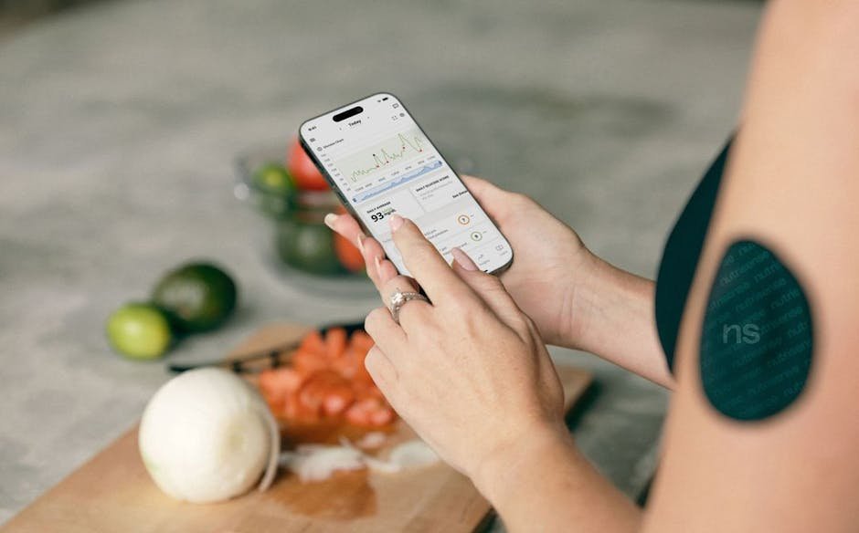 How AI Can Improve Your Life in 2026: Part 12 - Track Nutrition Without Manual Logging 2 Woman using a smartphone app to track nutrition with fresh vegetables in the background