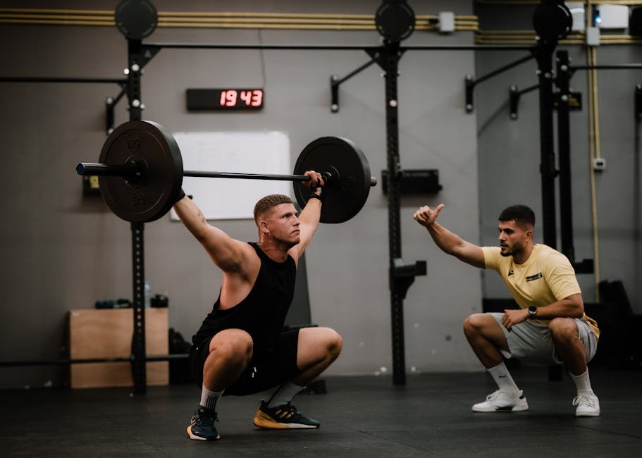 How AI Can Improve Your Life in 2026: Part 14 - Get Real-Time AI Fitness Coaching 1 A muscular man performing a weightlifting squat with a coach guiding him