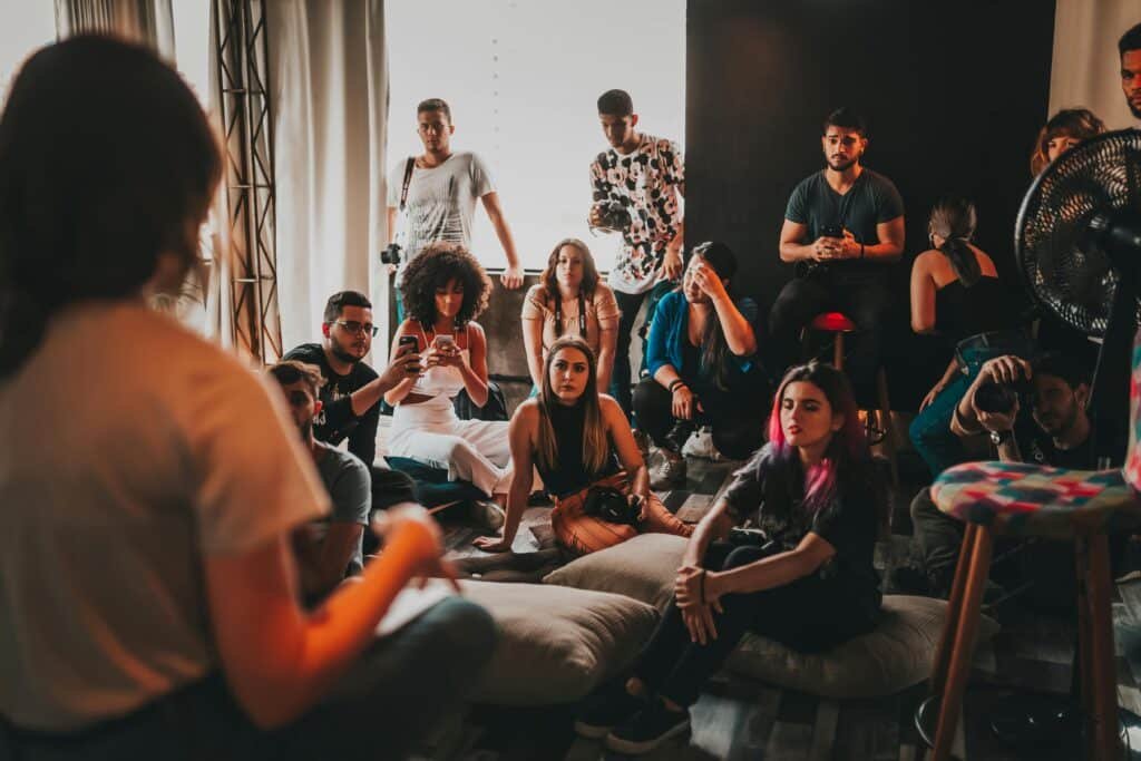 How AI Can Improve Your Life in 2026: Part 15 - Practice Languages with AI Conversation Partners 2 A diverse group gathered indoors for an engaging language discussion session.