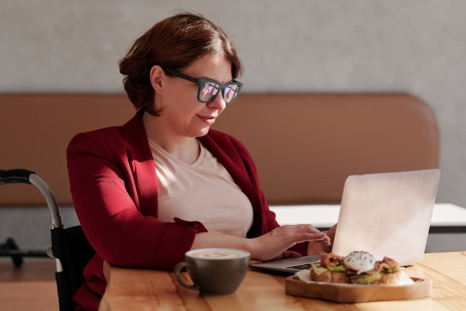 How AI Can Improve Your Life in 2026: Part 12 - Track Nutrition Without Manual Logging 4 Professional woman in red blazer working on laptop at cafe with coffee and snack