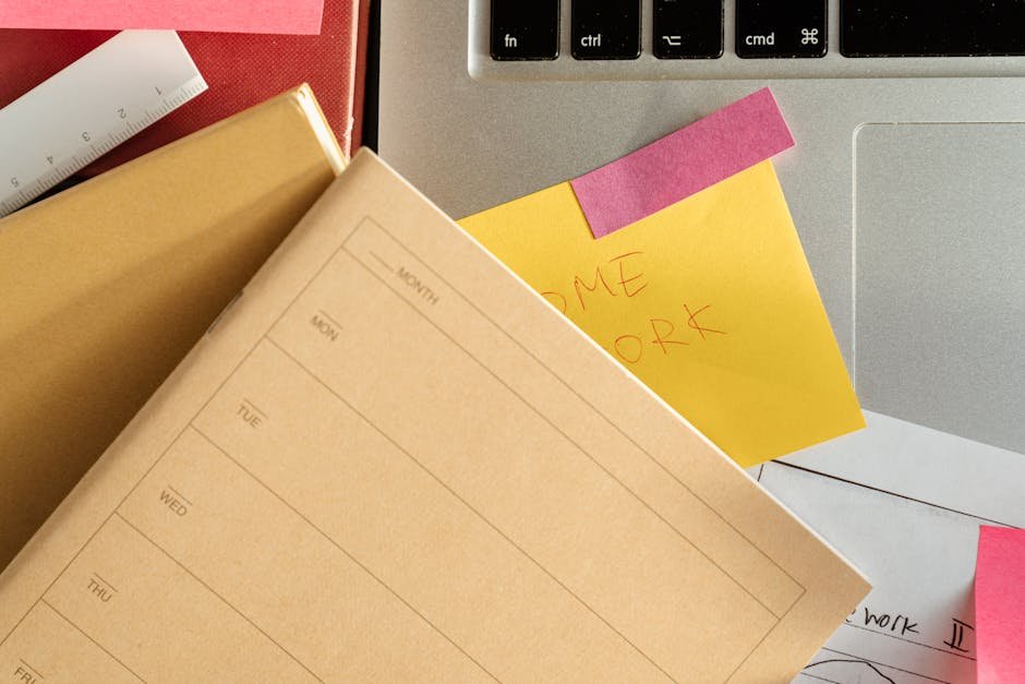 Top view of study desk with laptop notebook and colorful sticky notes for organization