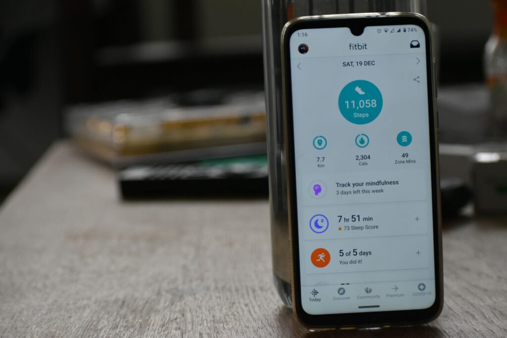 Close-up of a smartphone displaying a fitness tracking app with health statistics.