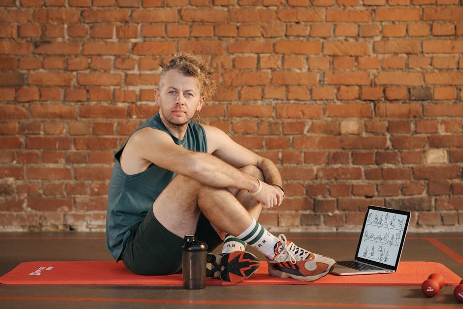 Man using AI workout recommendations app on laptop for home exercise