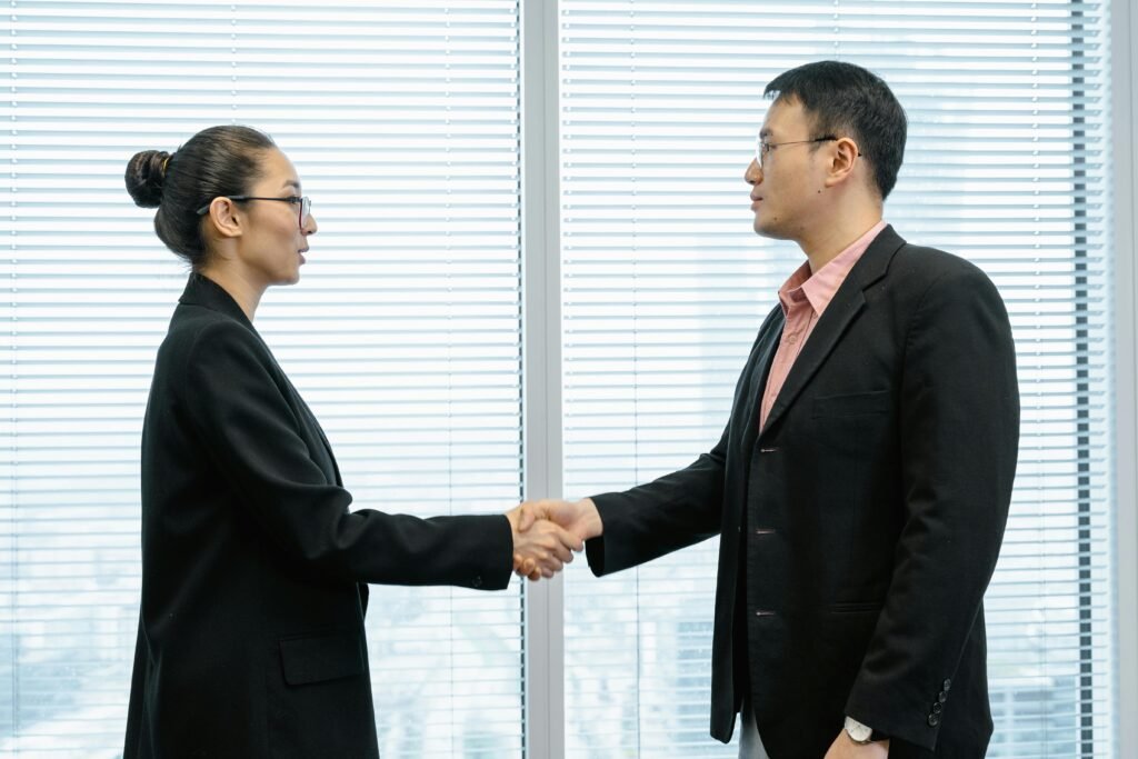 AI salary negotiation - two professionals shaking hands after successful offer
