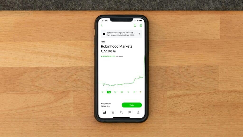 Mobile investing app on smartphone showing stock prices and AI portfolio optimization features