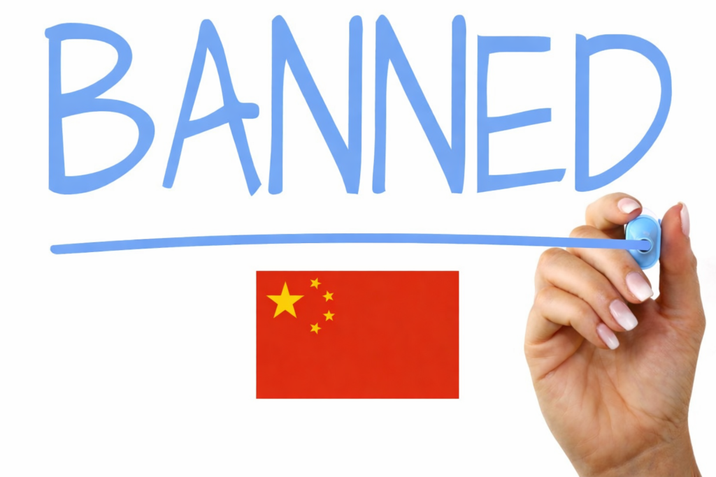 Apple Siri Gemini Deal: What the $1 Billion Google Partnership Means for Your iPhone 5 The word BANNED written in large blue marker letters with an underline on a white background, a hand holding a blue marker at the right edge, and a small red Chinese flag centered below the underlined word.