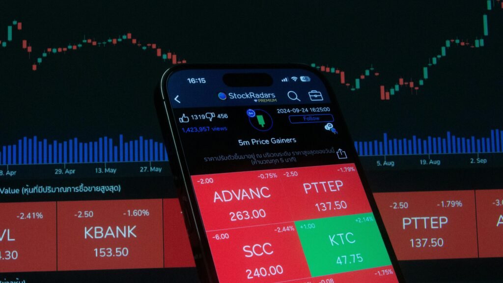 Mobile screen displaying stock market analysis with financial charts in the background.