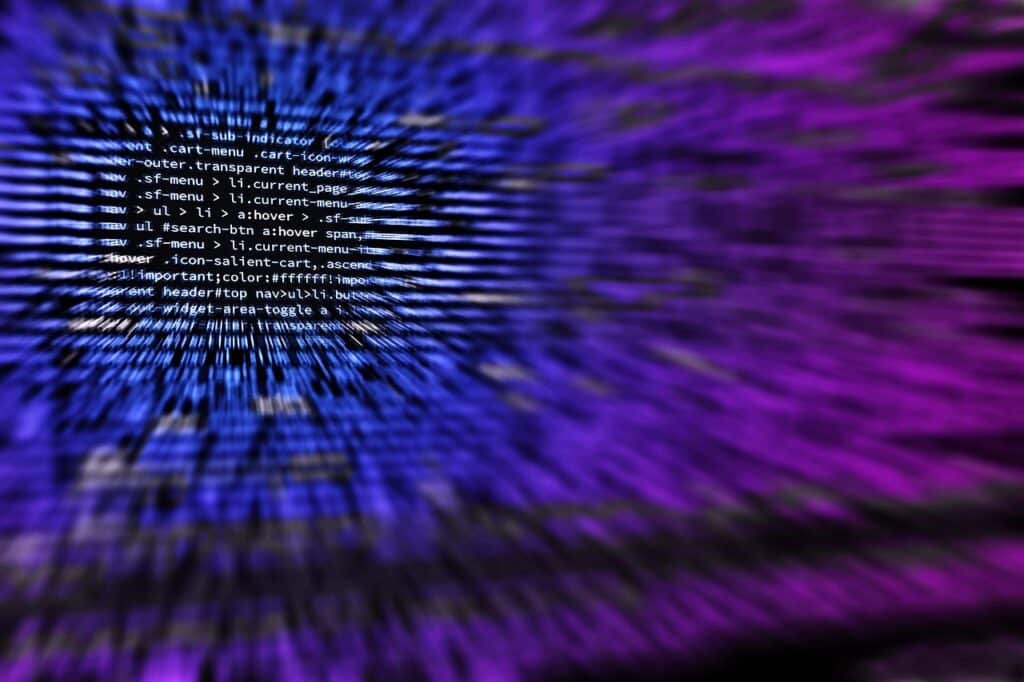 Source code on a dark screen with a blue and purple motion blur effect