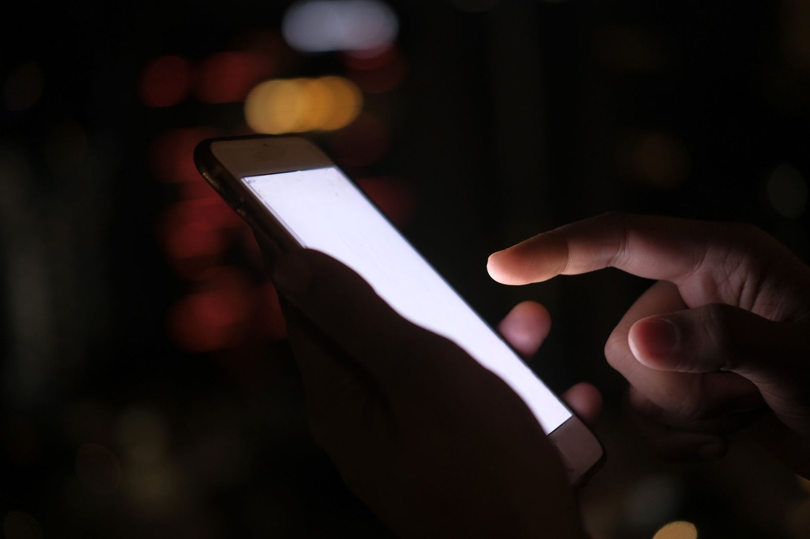 Meta Killed the Instagram AI Photo Feature. The Backlash Actually Worked. 3 Hand using a smartphone in the dark, checking Instagram privacy settings