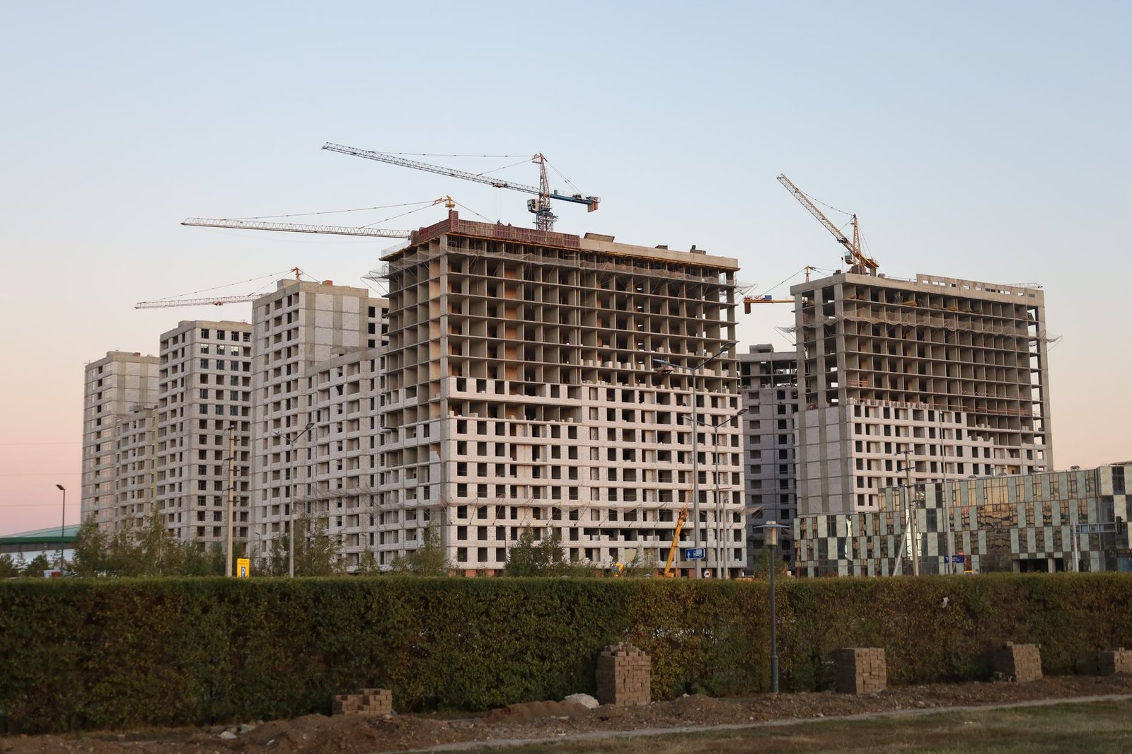 Construction site with tower cranes at sunset, the scale of what people have built with Claude Fable 5 so far