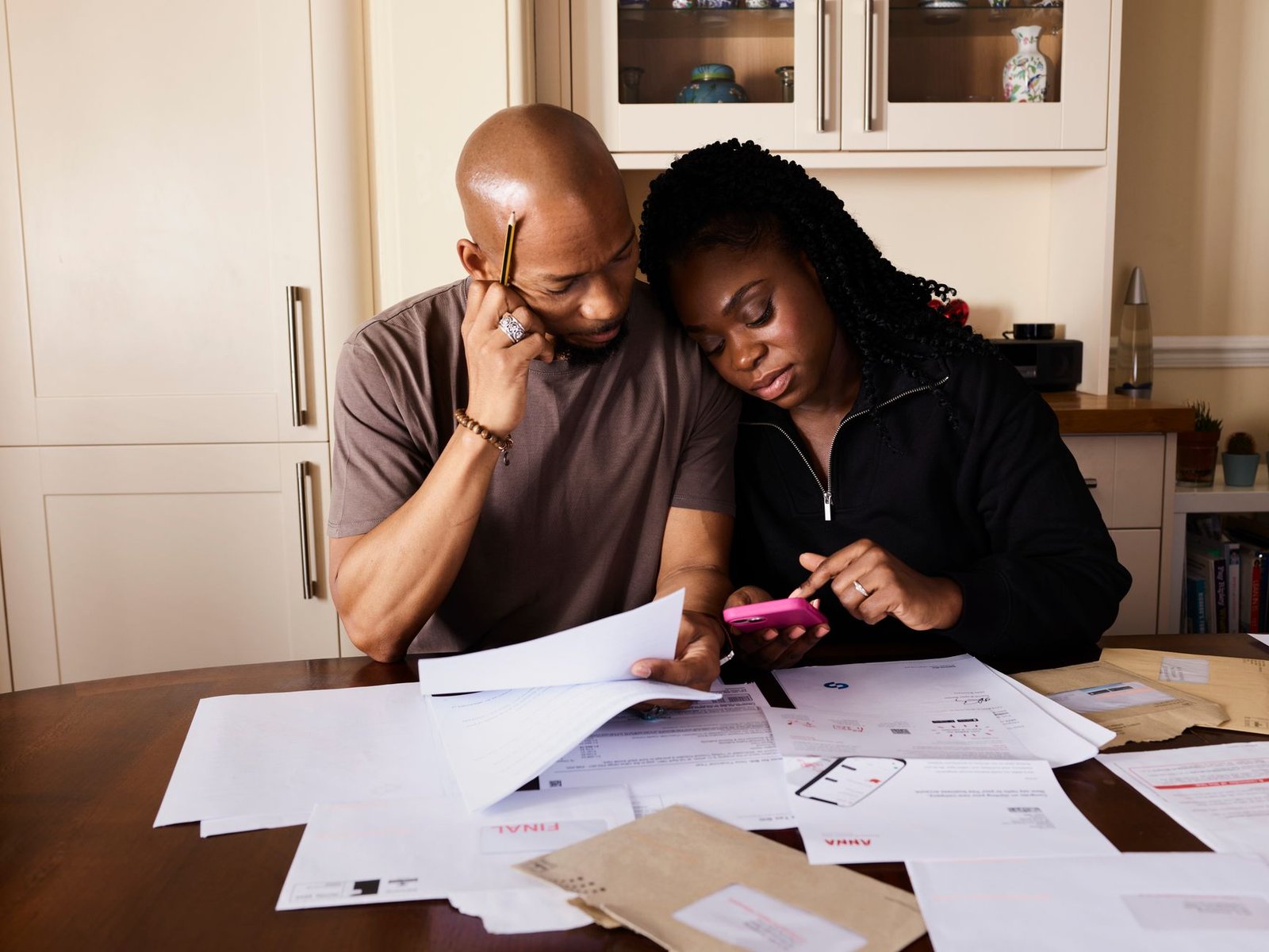 A couple at a table going through household finances as energy and tech costs rise