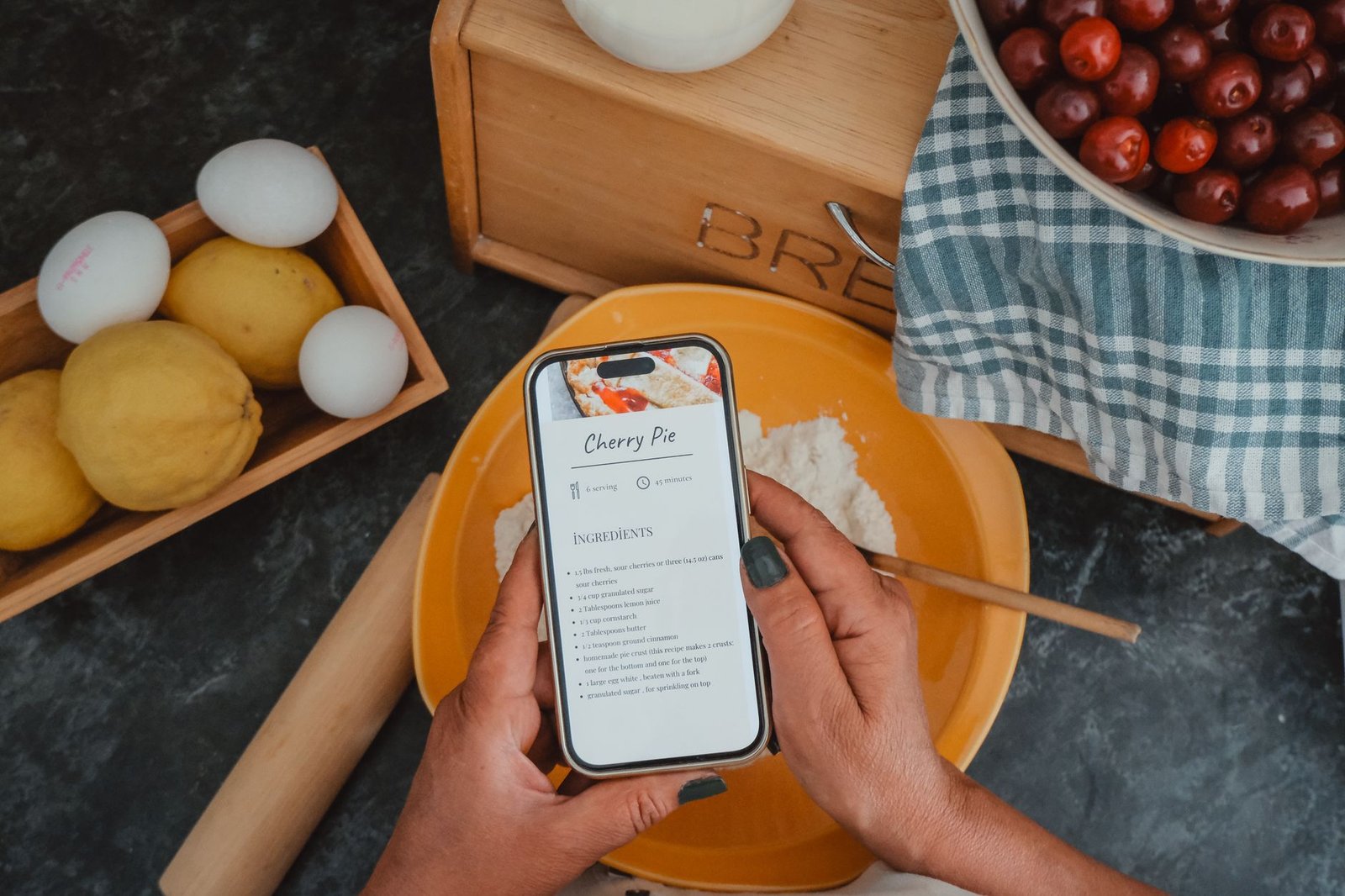 ChatGPT Can Finally Handle Being Interrupted. What GPT-Live Changes for You. 2 Hands holding a phone with a recipe open while cooking, a perfect hands-free GPT-Live moment
