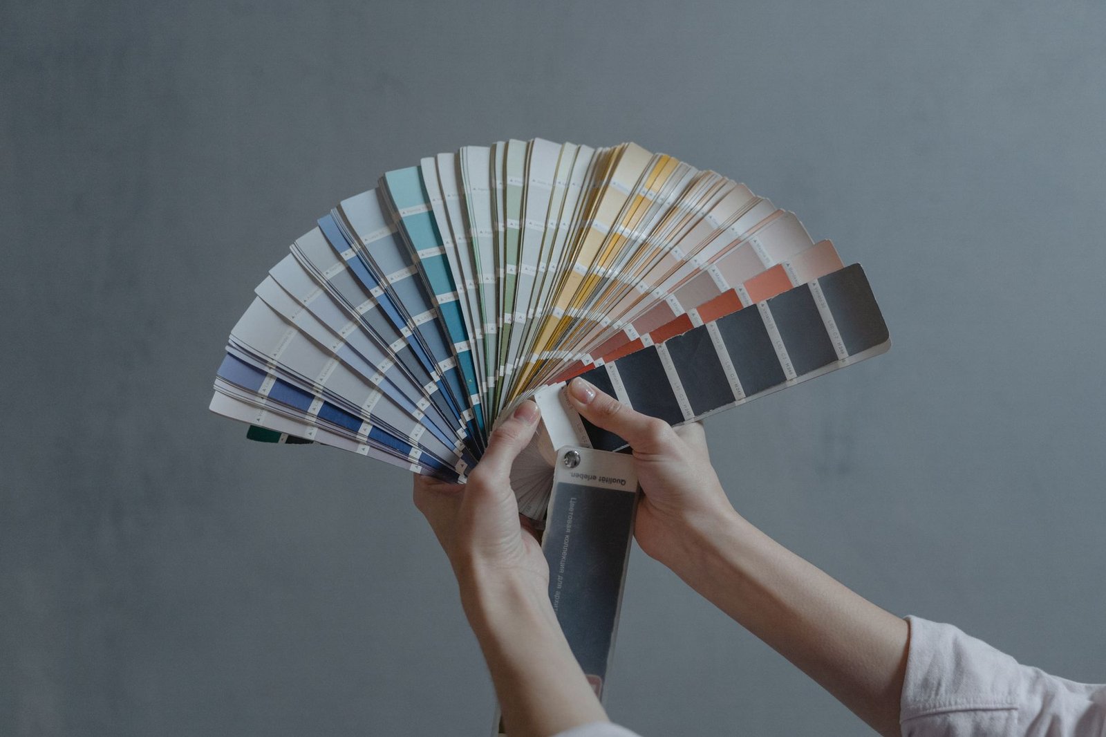 AI Presentation Maker Showdown: Gamma vs Canva vs Beautiful.ai 4 Hands holding a fan of color swatches, a metaphor for locked brand controls