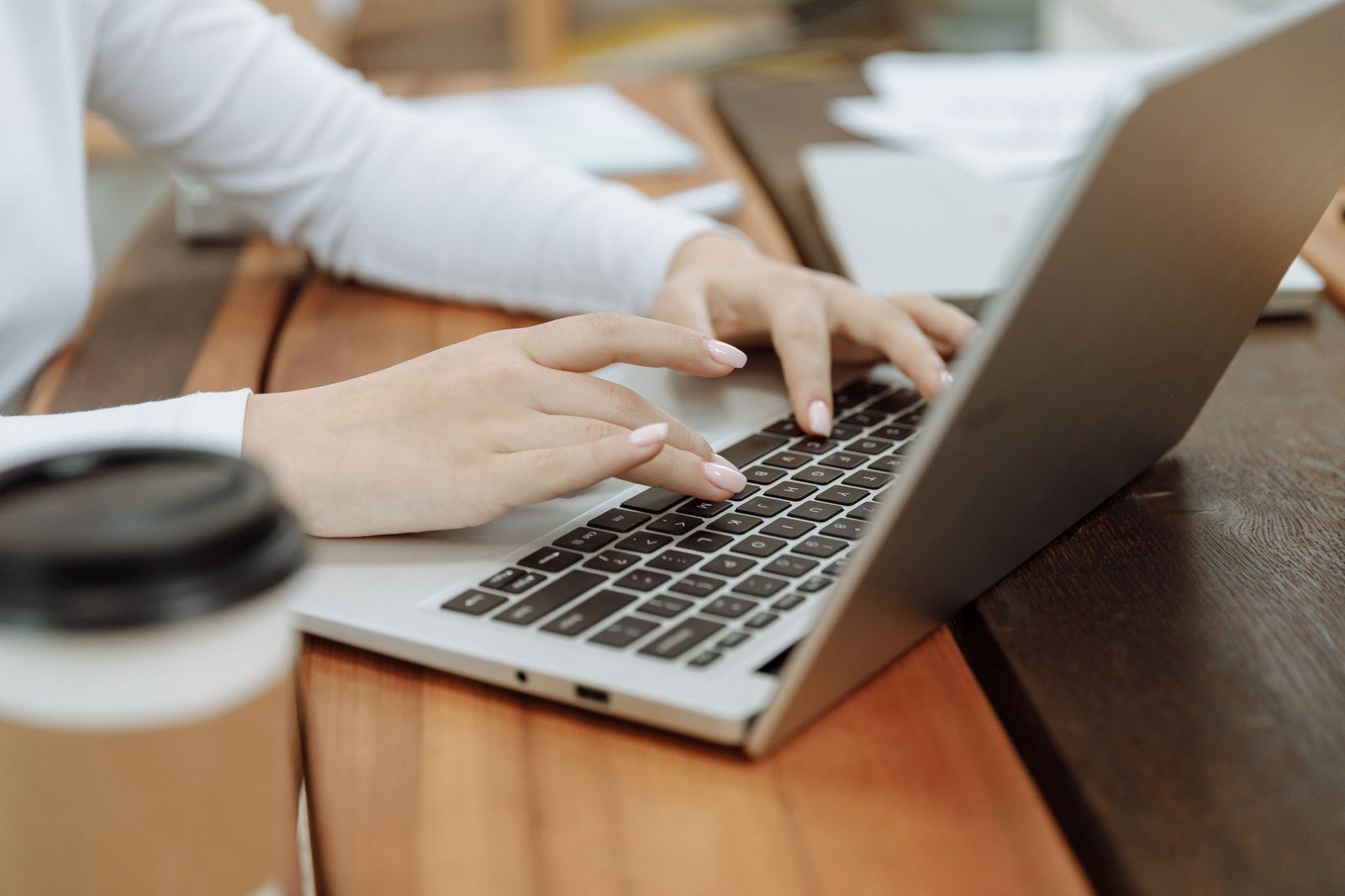 AI Presentation Maker Showdown: Gamma vs Canva vs Beautiful.ai 2 Hands typing on a laptop, using an AI presentation maker to draft a deck