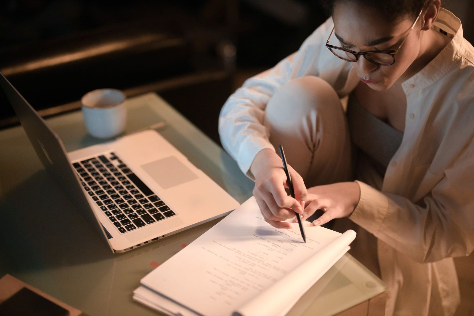 Gemini Study Notebooks: How Google's Free AI Tutor Actually Works 5 Adult taking notes at night while studying at home for a certification