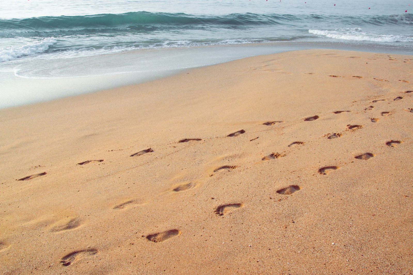 ChatGPT for Teens: What Parents Can Actually Control 3 Footprints leading across a beach, a stand-in for the usage signals ChatGPT for Teens reads to guess a user is under 18