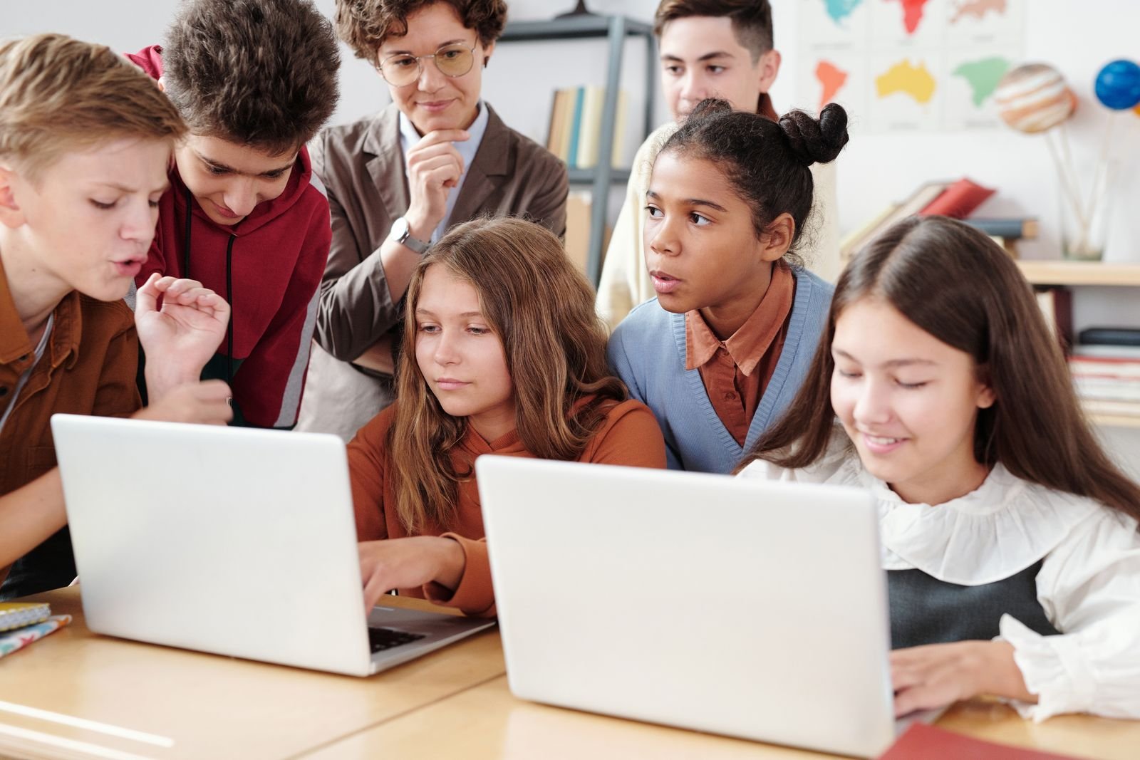 Gemini in Classroom Just Opened to K-12. There's No Parent Off Switch. 1 A group of middle school students gathered around two laptops in a classroom