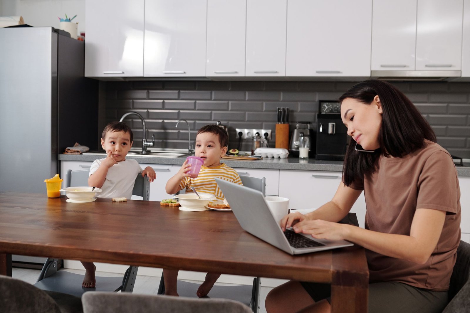 A parent juggling a laptop and breakfast, the busy inbox owner Gmail AI Inbox is built for