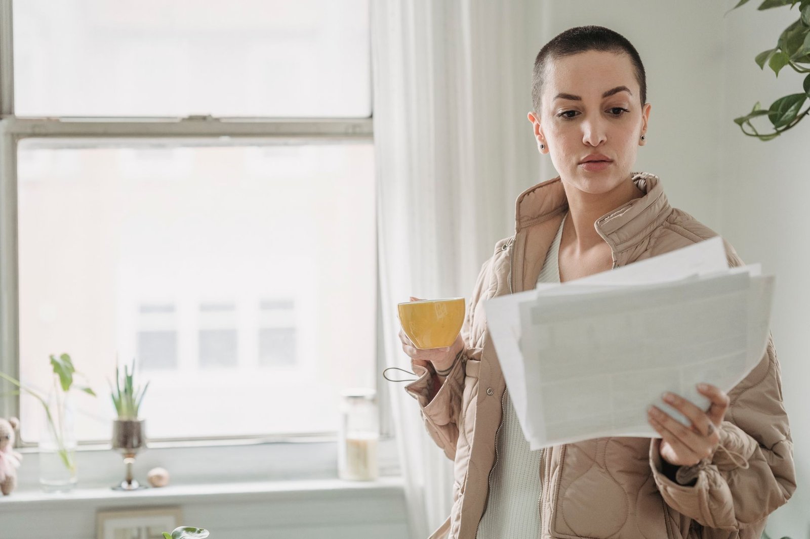 A person reading a printed summary with morning coffee, the way AI Inbox hands you a briefing
