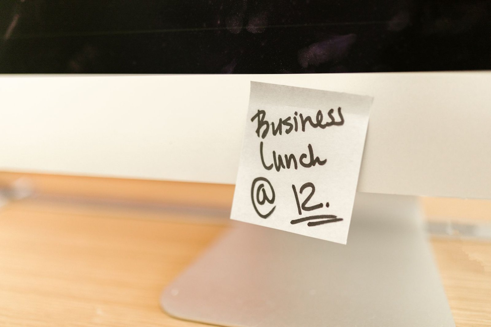 A sticky note reminder stuck to a computer monitor, the analog version of the Gmail AI Inbox to-do list