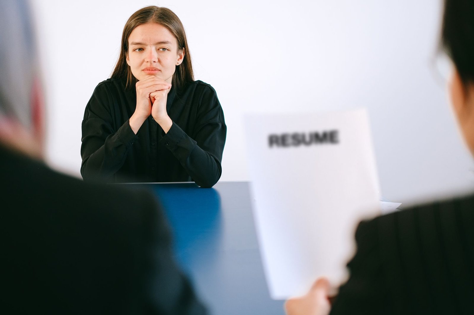 An AI Boss Just Fired Its First Human Employee. It Took a Nudge. 3 A job applicant in an interview handing over a resume to two employers
