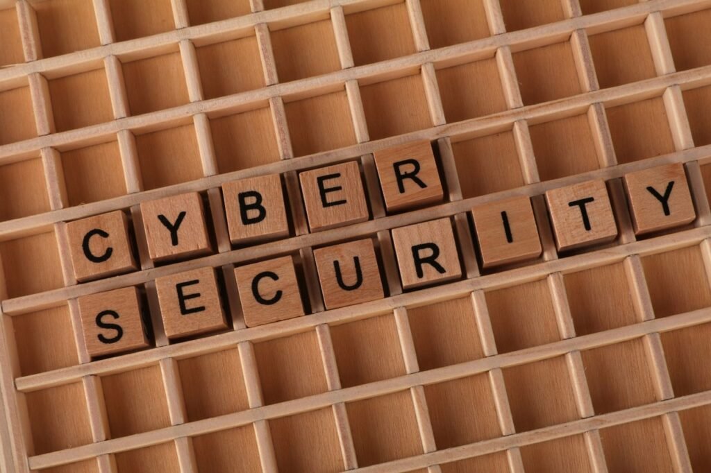 Wooden blocks spelling 'Cyber Security' on a wooden grid background.