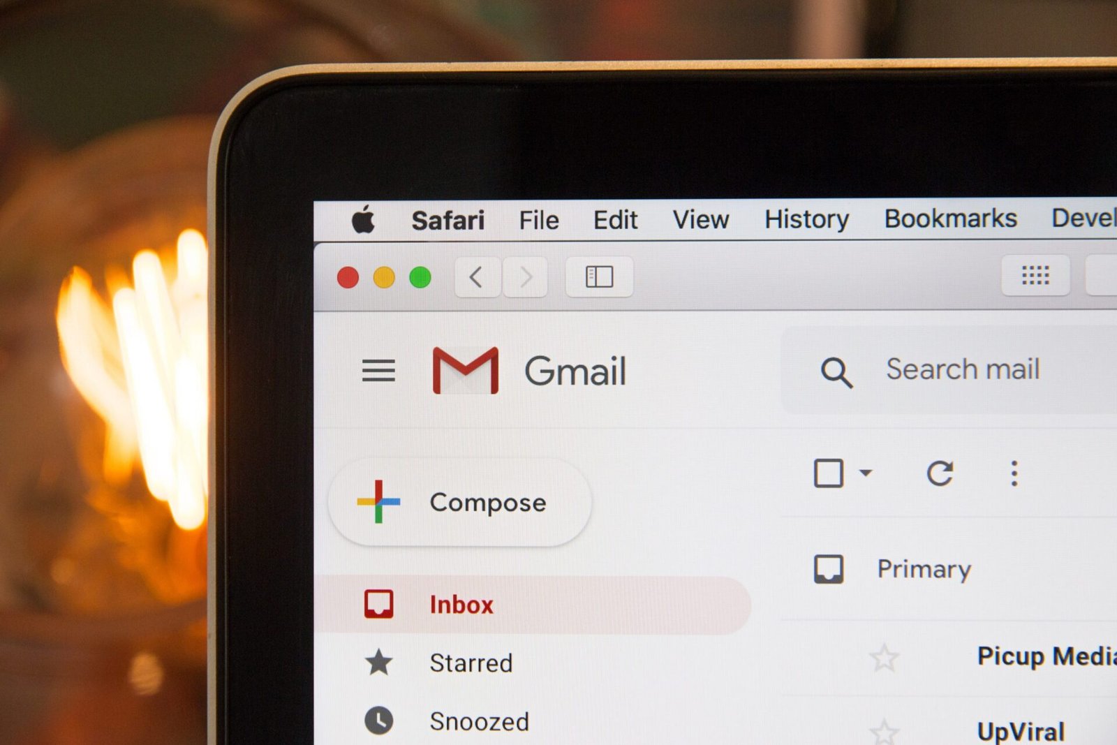 Person reading email on a laptop, the kind of inbox event that can trigger a ChatGPT webhook task