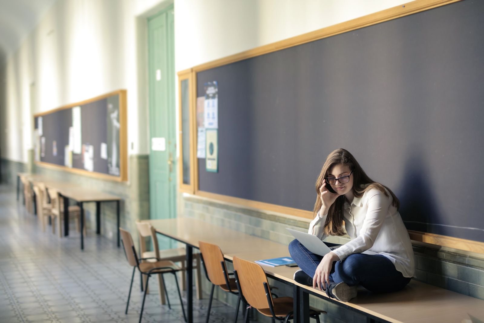 College student on a laptop in a university hallway, signing up for Google AI Pro free for students