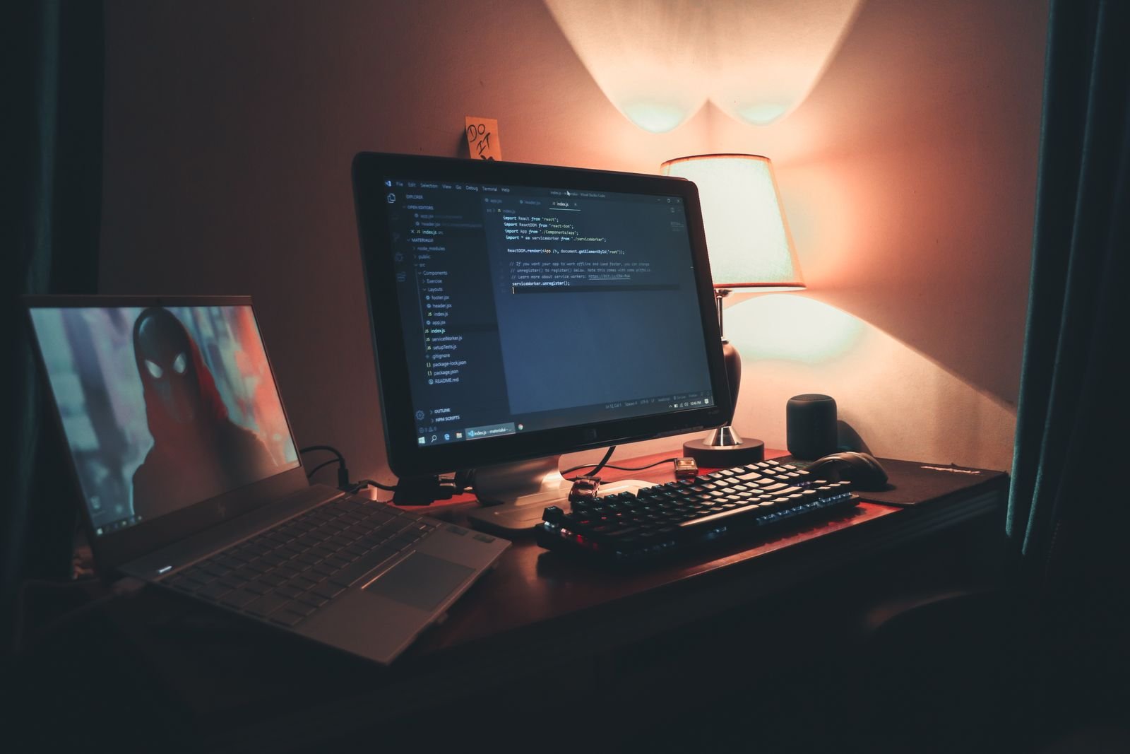 Home office with two monitors showing code, where AI coding assistants like Claude Code and Codex do their work