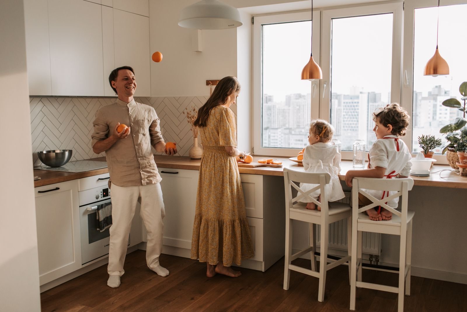 A family in a bright kitchen, the kind of room an Apple Home Hub with face recognition would sit in