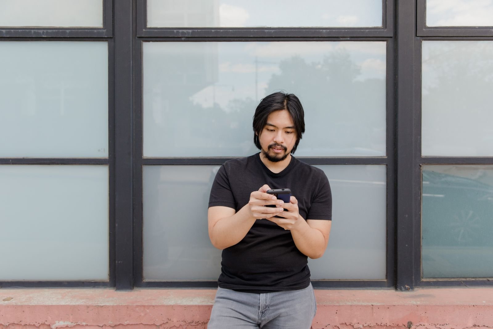 Person staring at a phone screen while waiting, the way ChatGPT errors have left Plus and Pro users this week