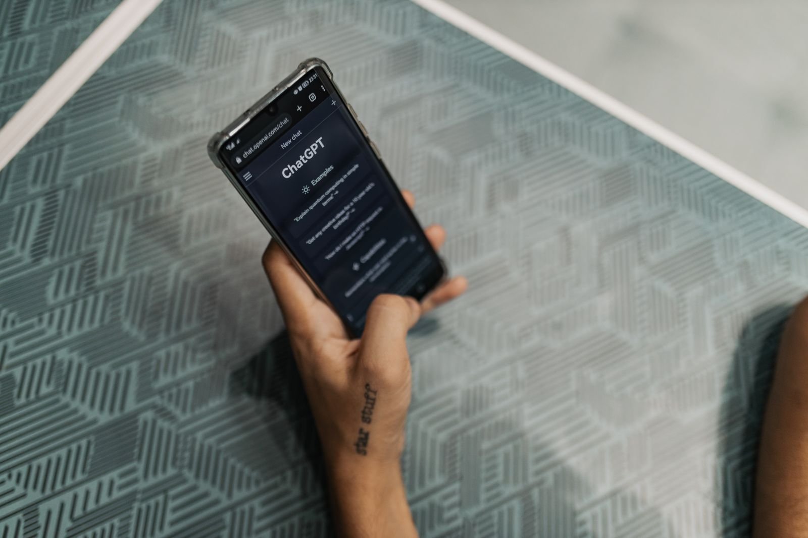 ChatGPT Instant vs Thinking: a person holding a phone with the ChatGPT app open