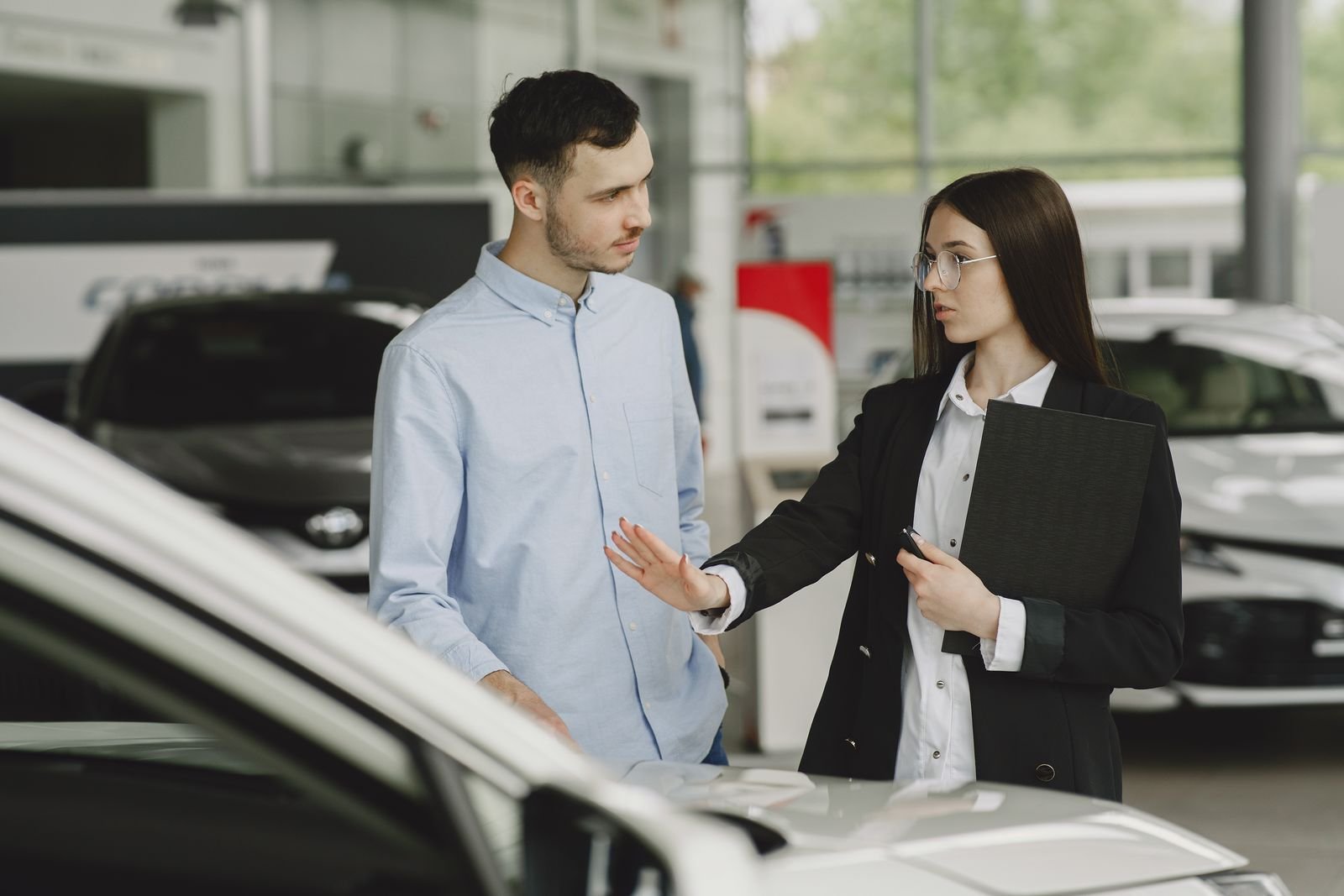 ChatGPT Now Has Sponsored Agents. Here's Who You're Actually Talking To. 1 Salesperson talking with a customer in a showroom, the in-person version of what ChatGPT sponsored agents do inside a chat