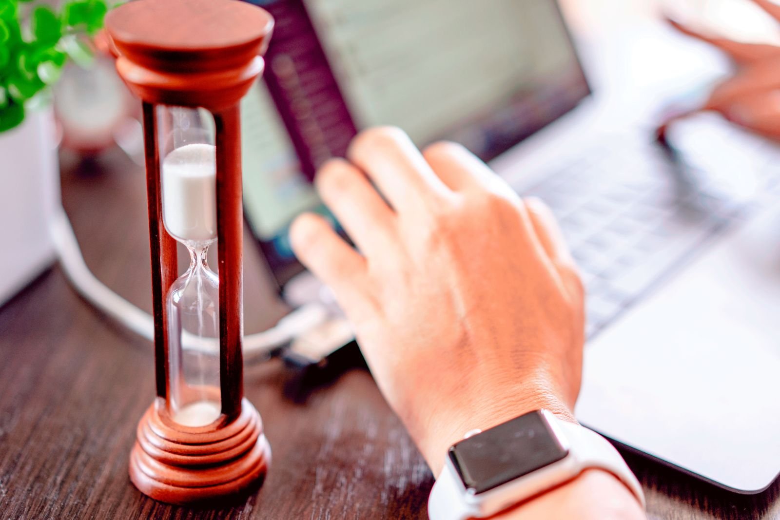An hourglass next to a laptop, waiting for a Claude usage limit to reset