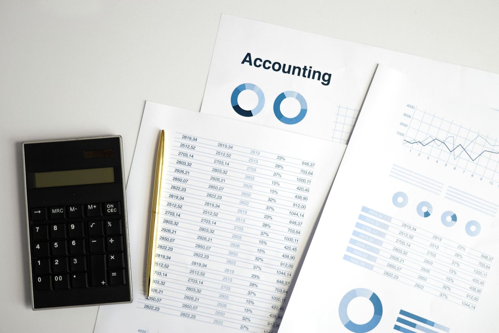 Calculator and printed charts on a desk, standing in for the FBI's first count of AI-related fraud losses