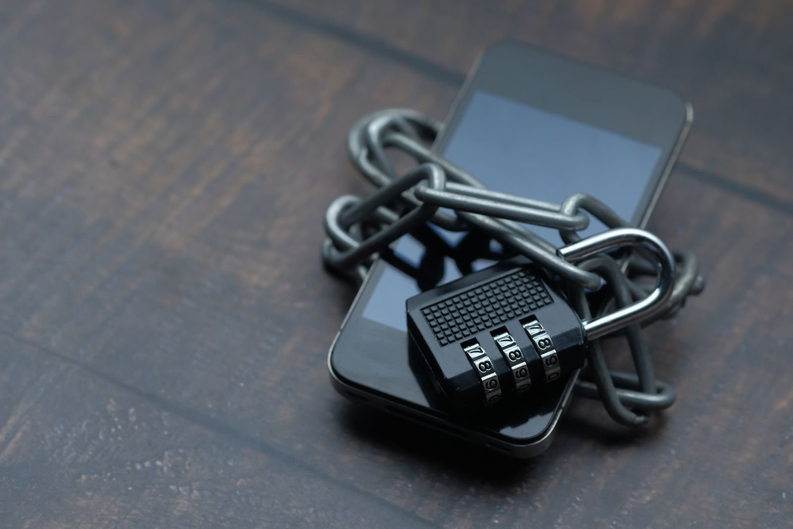 Meta Muse vs ChatGPT: What the No. 1 AI Agent App Actually Does 3 A smartphone wrapped in a chain and padlock, standing in for the question of whether Meta Muse is safe