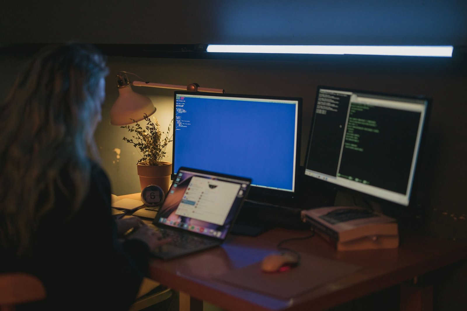 Claude Code Usage Limits Are Dropping 17%. Fable 5.1 Doesn't Cancel That Out. 4 Person working across several screens at once in a home office