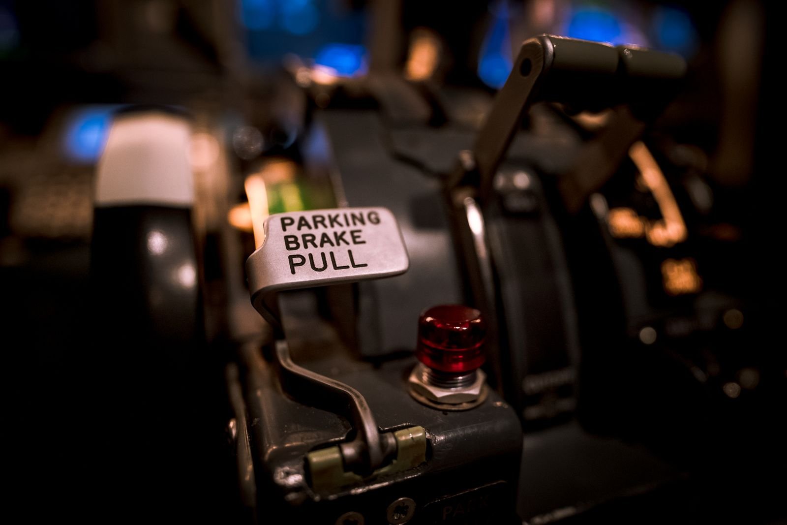 A cockpit parking brake lever, standing in for the three-step pacing plan behind the AI slowdown
