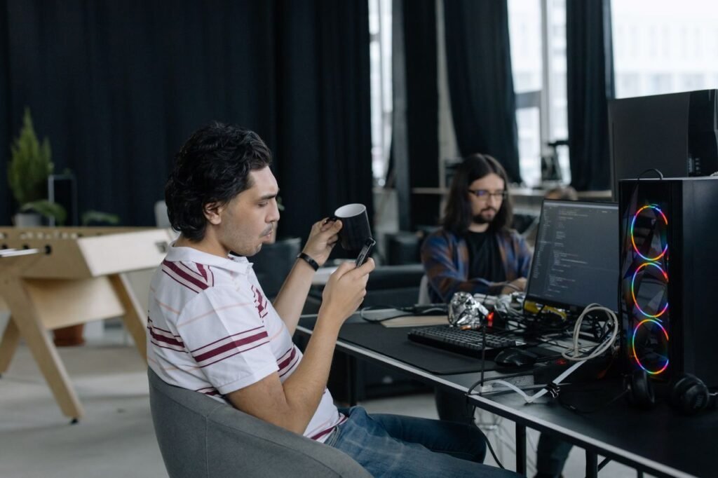OpenAI's $500 ChatGPT Pro Max Plan Isn't for Every Month. It's for the Busy Ones. 2 Two programmers at work in a modern office, focused on coding and enjoying a coffee break.