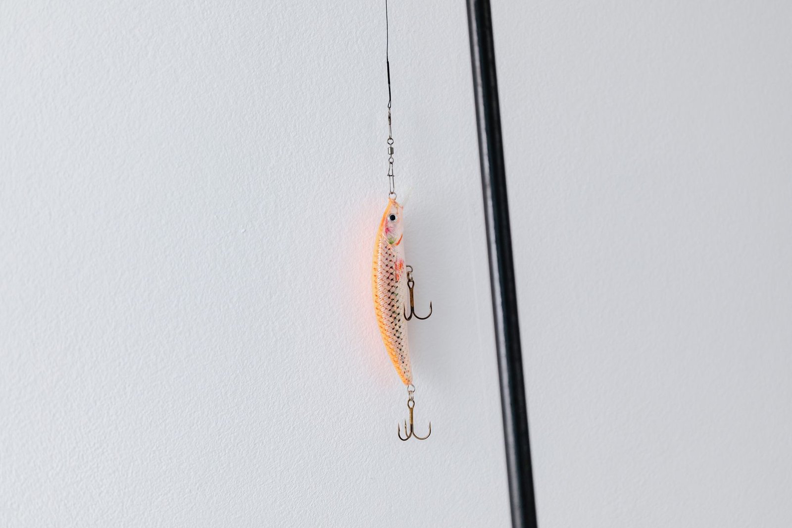 Close-up of a fishing lure on a rod, a stand-in for the deepfake ad that starts the funnel