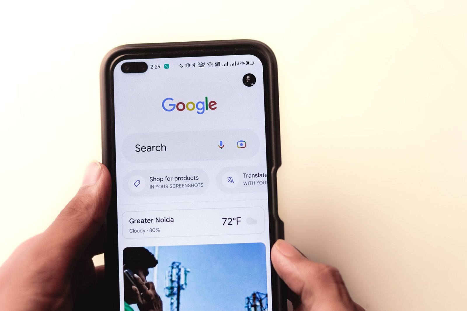 An Android phone in hand with the Google app open, where you turn off Gemini in Settings