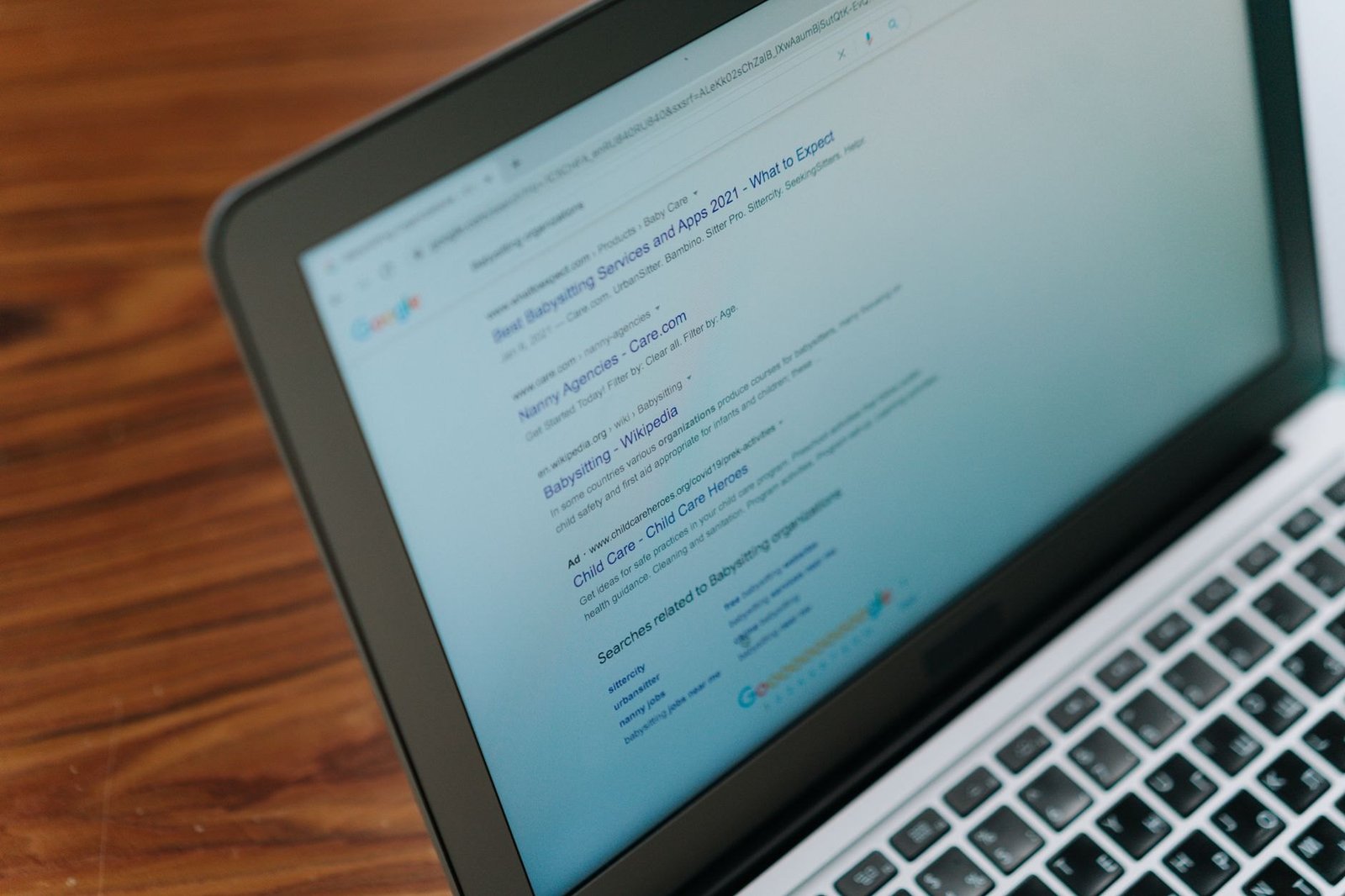 A laptop with Google search open in Chrome, where you can hide Gemini in Chrome settings